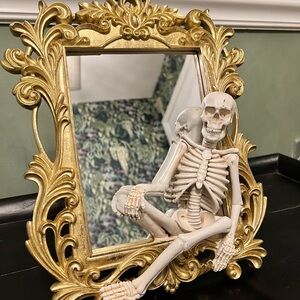 Gold Ornate Mirror with Skeleton Decor